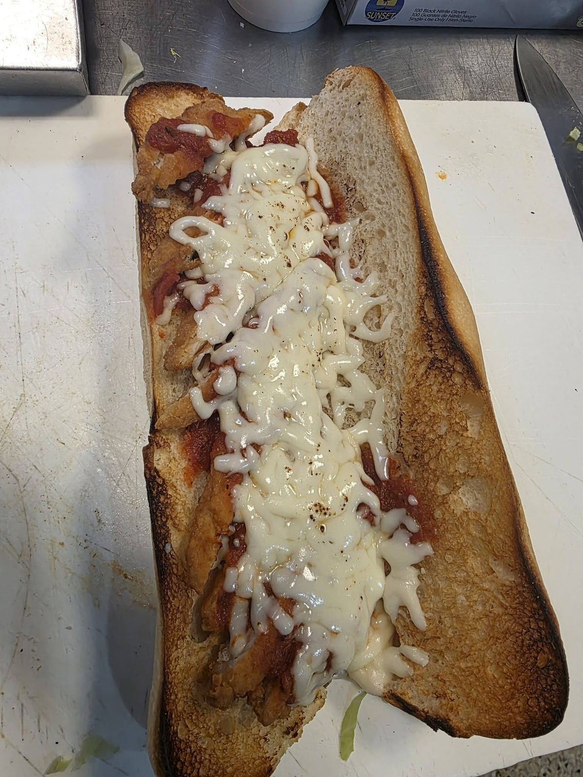 Toasted sub loaded with melted cheese, fresh off the grill