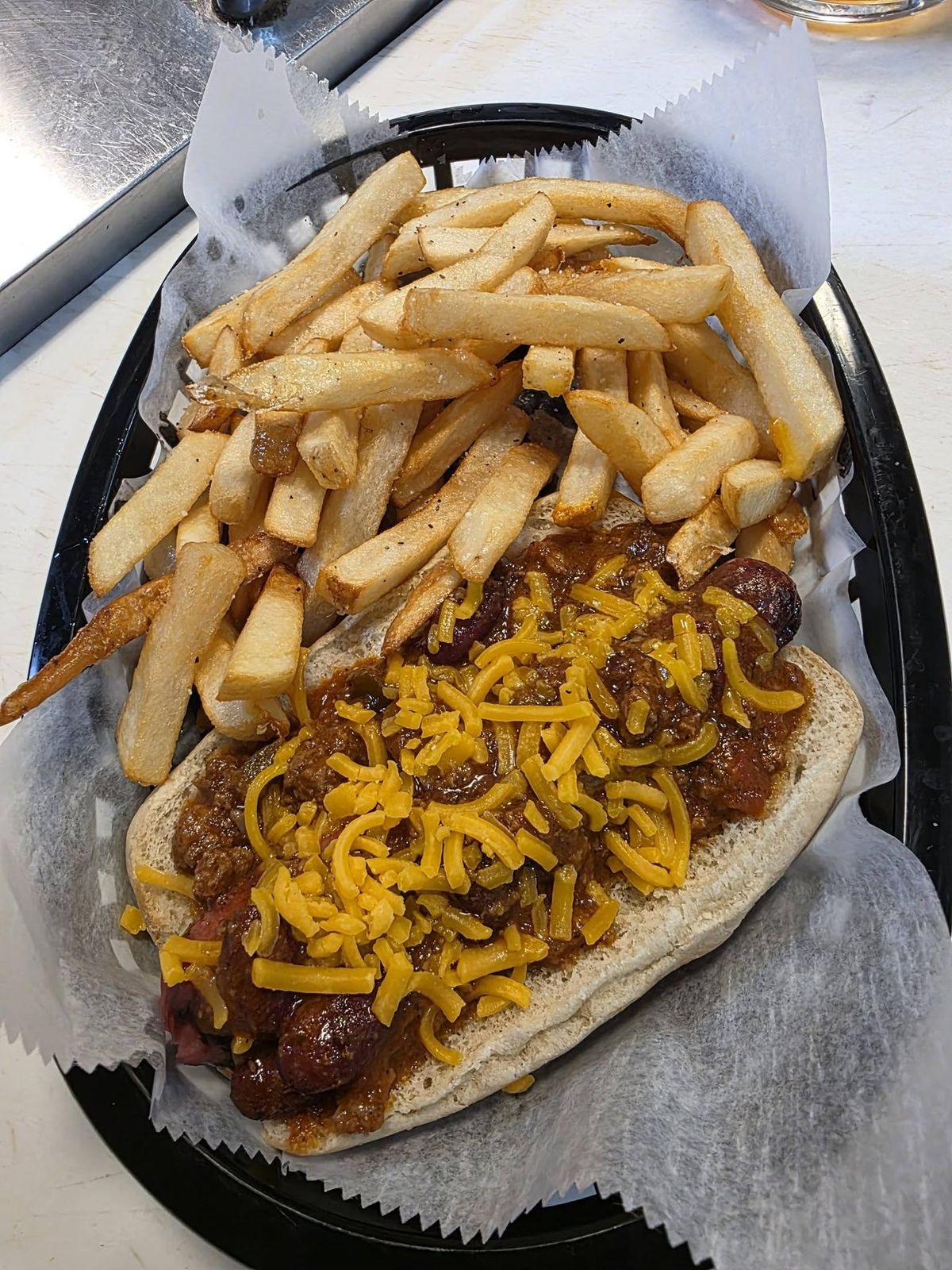 Chili cheese dog piled with chili and melted cheese